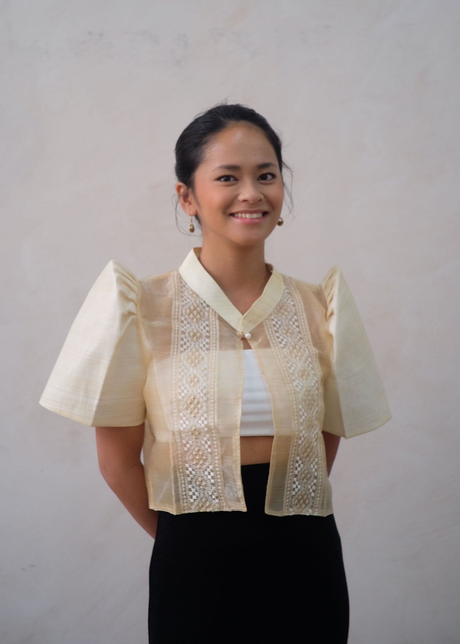 A cream embroidered Filipiniana bolero with butterfly sleeves in organza fabric, styled with a modern cropped cut and traditional Terno details.