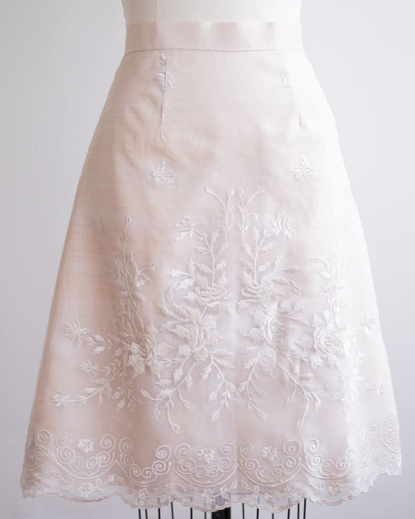 Elegant A-line Filipiniana skirt made of semi-sheer organza, featuring intricate white Rose floral embroidery and scalloped hem detailing. Made to order.