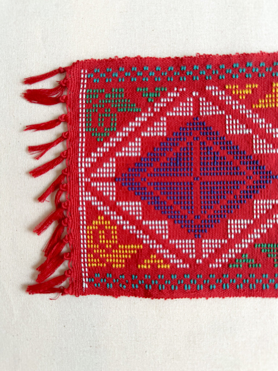Yakan Handwoven Cloth - Red Coaster. A traditional Yakan handwoven square in Red with vibrant blue, yellow, and green geometric patterns. A stunning piece of Philippine heritage, perfect for display or functional décor.