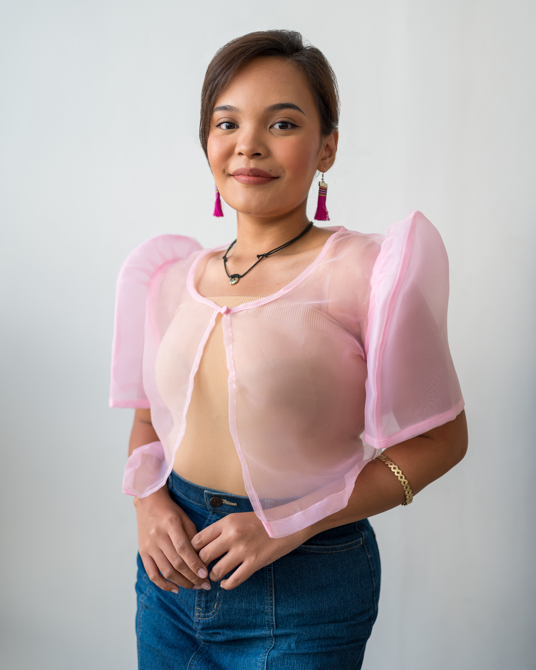 A baby pink sheer Filipiniana bolero crafted from delicate organza, showcasing modern design with subtle traditional details.