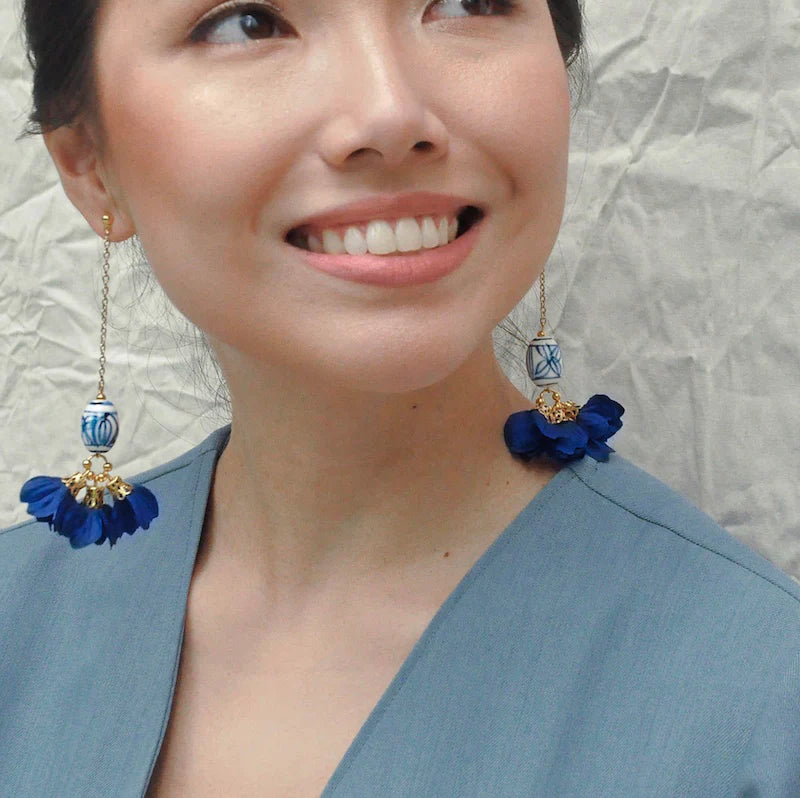 Porcelana Floral Earrings in blue and white hand-painted ceramic bead with gold-plated hardware and silk flower petals, handmade by Filipino artisans in a Chinese porcelain-inspired design.
