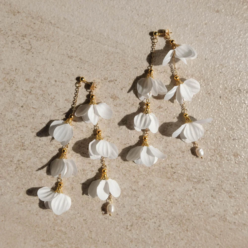 Delicate cascading Caida Bloom earrings with white fabric flowers and pearls, handcrafted by Filipino artisans.