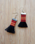 Black Kalinga tassel earrings made from handwoven red, yellow, and black fabric, Filipino artisan jewelry.