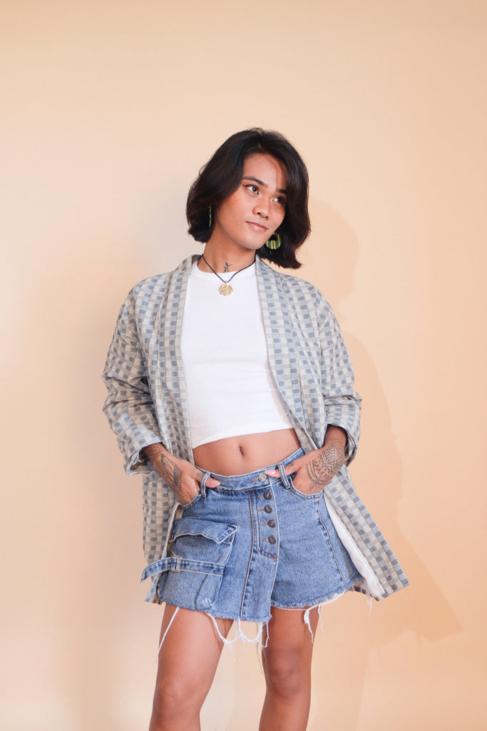 A Binakol jacket in Blue Gray features hand-loomed fabric from Abra, highlighting the mesmerizing patterns of traditional Filipino weaving. A bold statement piece that blends cultural heritage with modern style.
