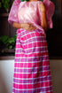 A handloomed Candy Sky checkered Patadyong from Iloilo, featuring bright pink, white, and blue plaid. It can be styled as a skirt, dress, or sarong.
