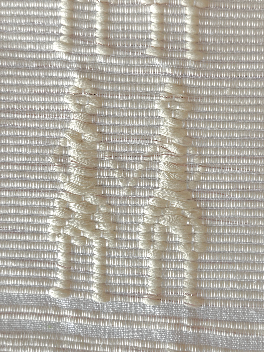 Handwoven Kibin Ilocos Placemat Set Placemat. A Handwoven Ilocos placemat with the &quot;Kibin Kibin&quot; pattern—figures holding hands in raised off-white motifs on fabric.