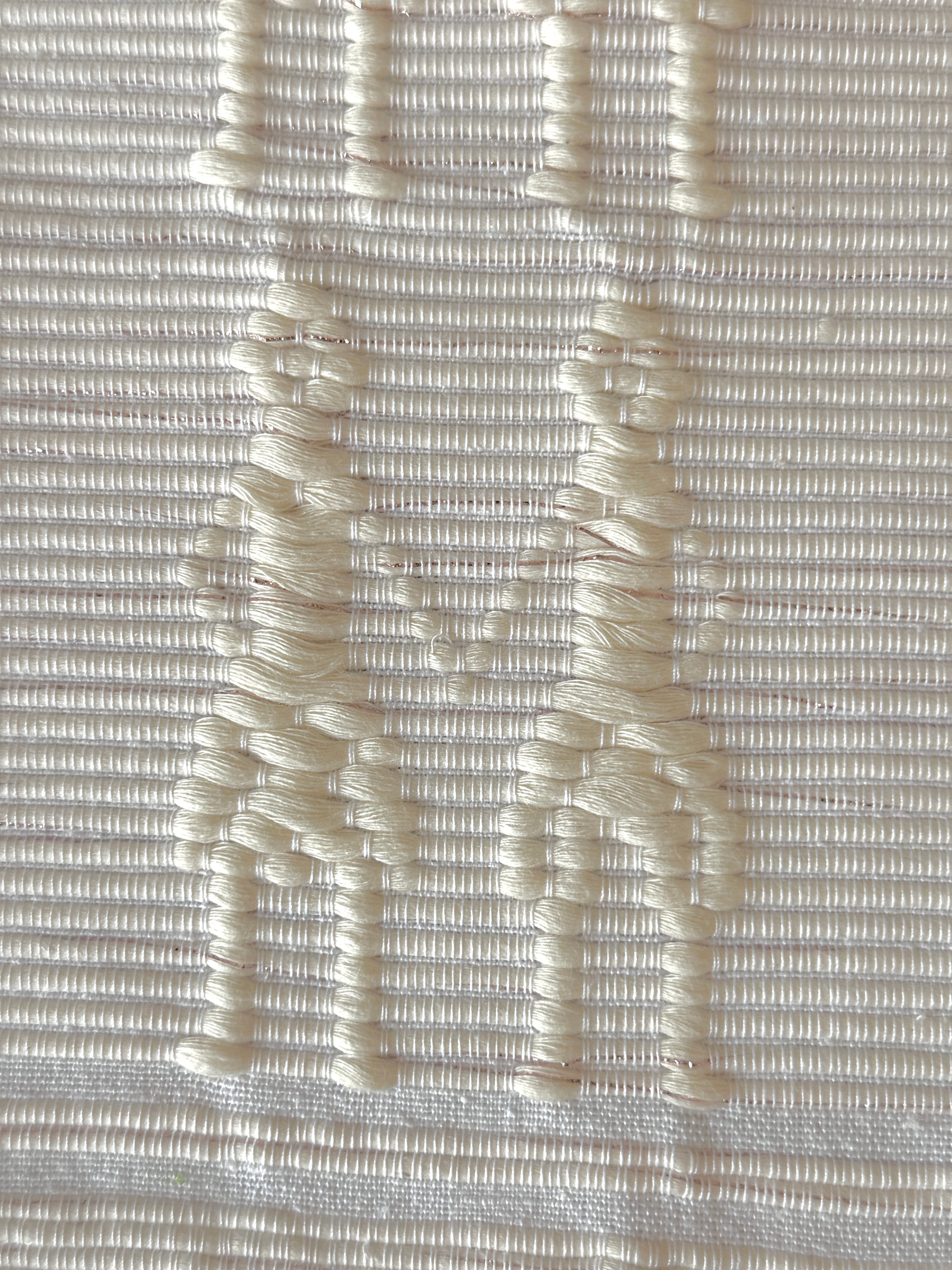 Handwoven Kibin Ilocos Placemat Set Placemat. A Handwoven Ilocos placemat with the &quot;Kibin Kibin&quot; pattern—figures holding hands in raised off-white motifs on fabric.