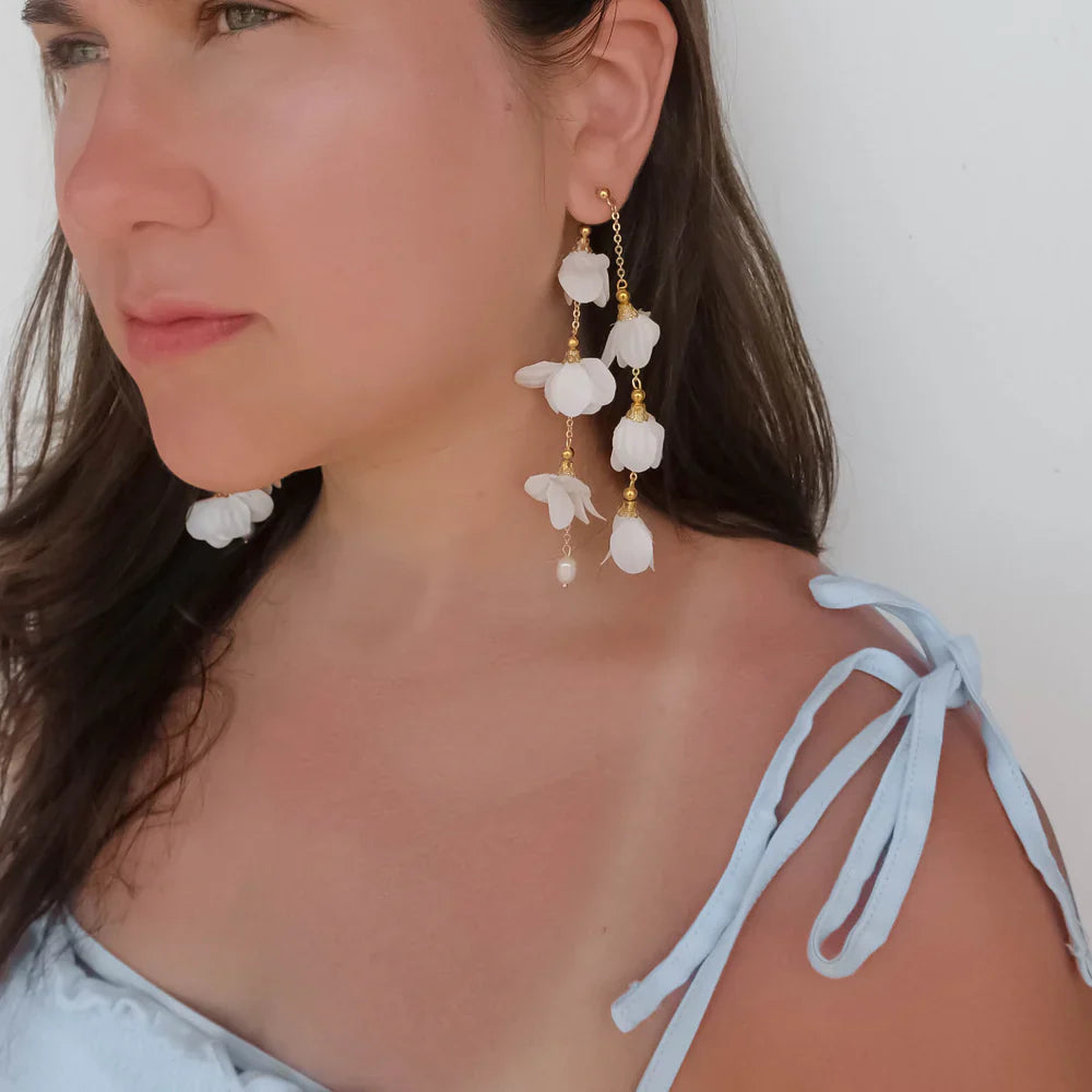 Delicate cascading Caida Bloom earrings with white fabric flowers and pearls, handcrafted by Filipino artisans.