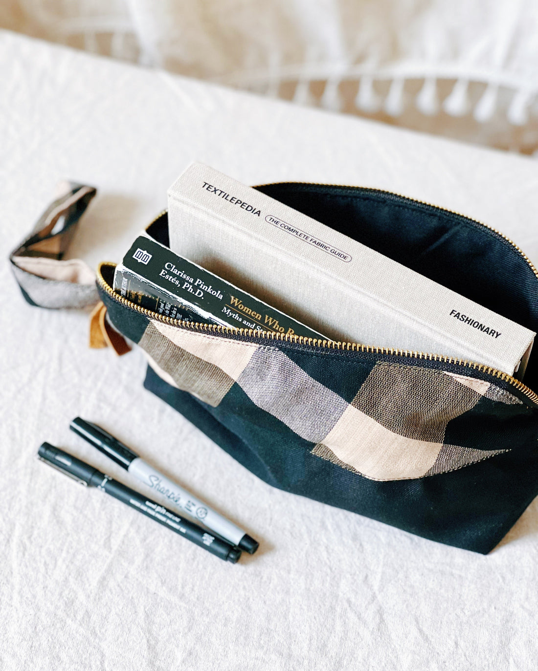 Woven Travel Pouch Unisex Bag
Handwoven Visayan travel pouch with a checkered pattern in earthy tones and a black fabric base, featuring a wrist strap and zipper closure. Perfect for organizing essentials at home or on the go.
