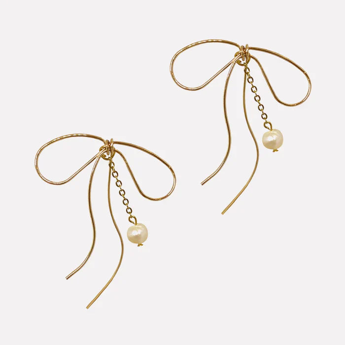 Lazo Threader Earrings with gold bow-shaped wire design and dangling pearl charm, handcrafted by Filipino artisans