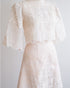 Filipiniana blouse and skirt set made of silk organza, featuring intricate rose floral embroidery and scalloped hems on the sleeves, blouse, and skirt.